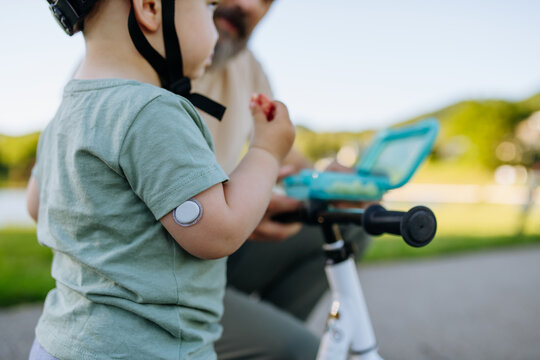 Boy with continuous glucose monitor eating snack to treat low blood sugar.