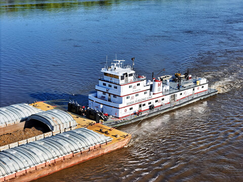 Savanna, Illinois - April 25, 2026; Aerial view of the  J.W. Hunter tug boat pushing a set of cargo barges South down the Mississippi River