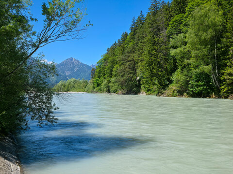 germany, crystal clear lech riverside panorama with alpine mountain backdrop and endless blue summer sky