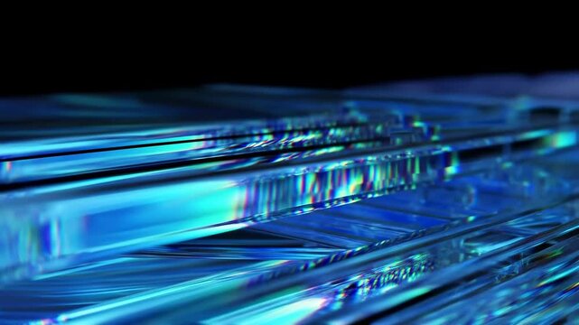 Tracking shot of layered glass slabs gliding and refracting light across reflective tabletop in dark studio environment with iridescent blue highlights and shallow depth of field