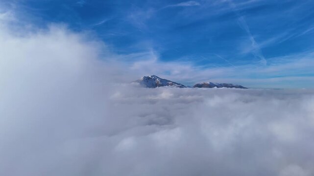 Aerial view flying directly above a thick cloud layer.