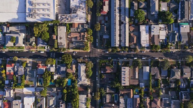 Top down aerial of residential Los Angeles neighborhood with houses, cars, traffic, swimming pools, capturing urban landscape and real estate in California