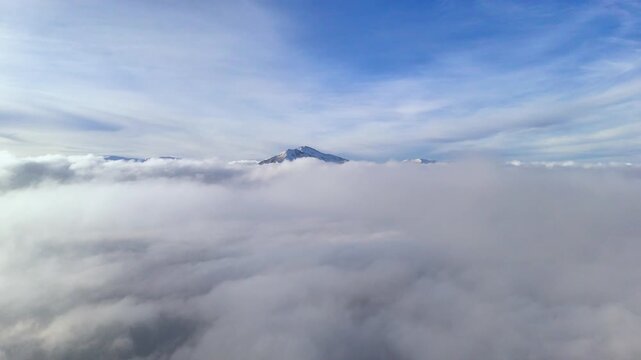 Cinematic drone flight through a high altitude cloudscape.