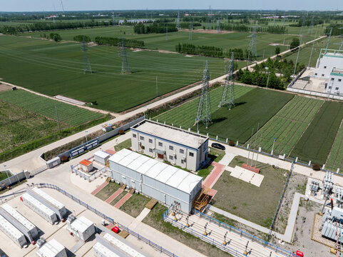 Aerial view of CNNC substation facility surrounded by green agricultural fields and power lines