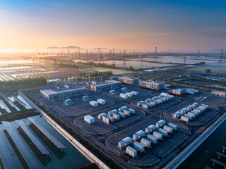 Aerial view of a large energy storage power station facility with solar panels at sunrise