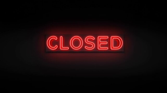 Slow zoomin of neon closed sign brightening on dark interior wall in nighttime storefront tracking toward illuminated red letters