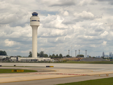 Charlotte Douglas International airport air traffic control tower along a runway