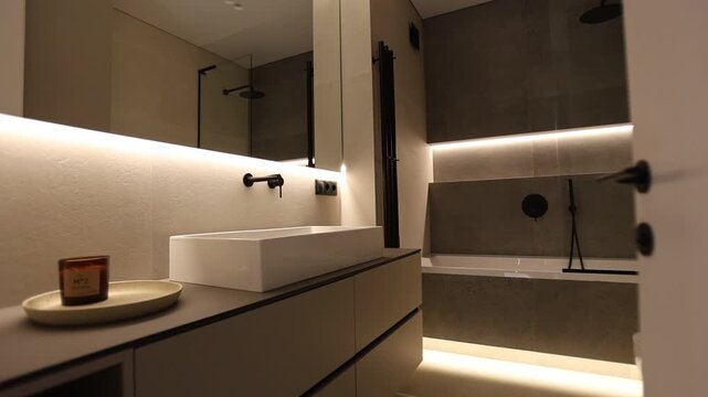 Modern minimalist bathroom interior with warm lighting and clean stone surfaces