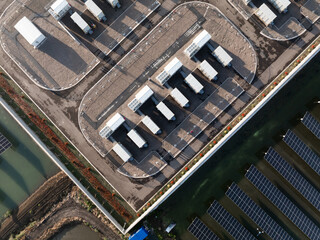 Aerial view of solar panels and charging stations on a modern industrial rooftop © zhu difeng