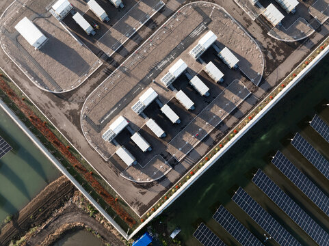Aerial view of solar panels and charging stations on a modern industrial rooftop