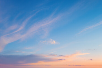 Fototapeta premium Beautiful sunset sky background with soft clouds. Pastel sunrise sky texture representing freedom, inspiration and serenity.