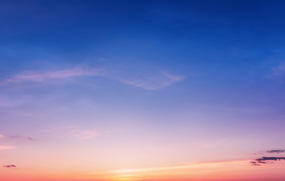 Vivid dusk sky background at sunset with calm atmosphere. Beautiful twilight sky background visualizing peace, harmony and tranquility.