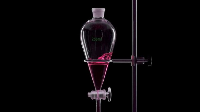 Rosy transparent fluid is injected into a separatory funnel, producing splashes within the liquid on solid black surface | Rose hydrosol skincare formulation development concept
