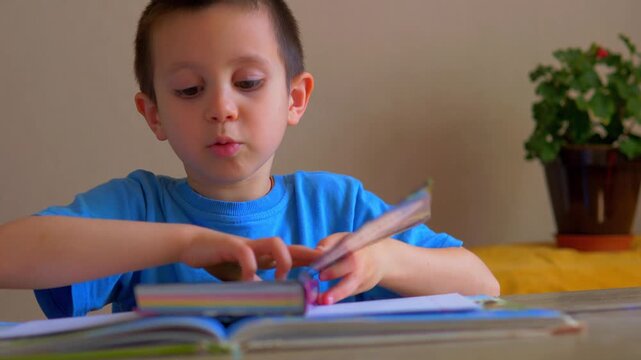 Young Boy Reading Book at Table &ndash; Child Studying and Learning at Home