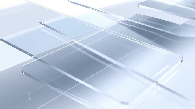 Slow tracking pan of transparent glass panels sliding and intersecting across reflective studio surface with soft bright lighting