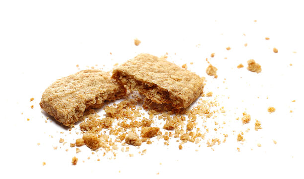 Biscuit with whole wheat flour and oatmeal, crunchy cereal with crumbs isolated on white background, side view