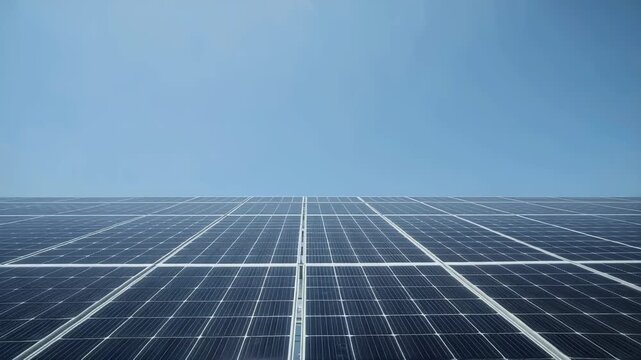 Solar panel array clear blue sky with bright reflective photovoltaic module array sunlit geometric