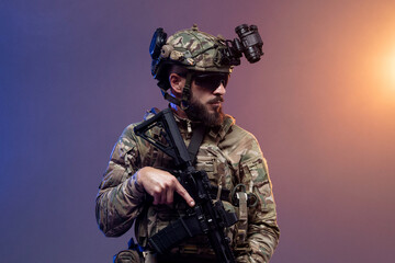 Fototapeta premium Military professional in camouflage uniform with rifle and night vision device on isolated background. Concept armed forces and tactical operations. 