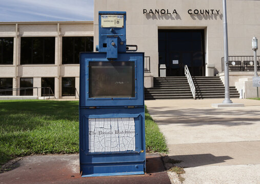Carthage TX - September 28, 2025: Panola County Courthouse and Empty Newspaper Stand Located in Downtown Carthage TX
