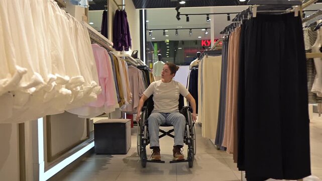 A Caucasian woman in a wheelchair shopping at a mall. 