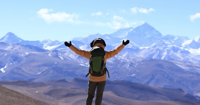 Successful woman hiker open arms to Mount Everest in Tibet, China