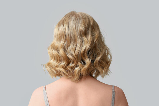 Blonde wavy bob hairstyle from behind, hair care and beauty salon concept, healthy hair texture and volume