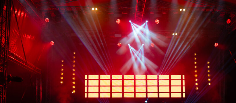 Concert stage lights and video screen on the summer night live performance