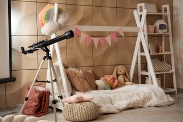 Children's bedroom interior with telescope, teepee bed, and playful decor for imaginative learning and exploration © Pixel-Shot