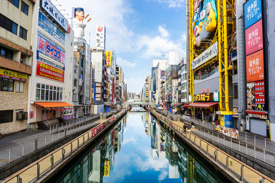 Cityscape of Dotonbori in Osaka with reflections on Dotonbori Canal. It's the premier entertainment hub of Osaka making it an unmissable destination for culinary exploration and vibrant urban culture.