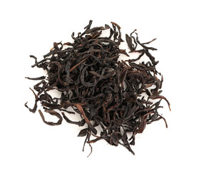 Heap of dry black tea leaves isolated on white background, closeup © Pixel-Shot