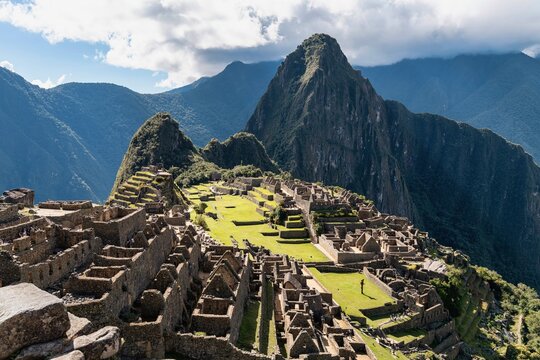 View of Machu Picchu With Ruins and Mountains Under a Partly Cloudy Sky in Peru During the Daytime