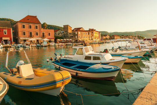 Vibrant motorboats docked in the harbor of Stari Grad, a historic town on Hvar Island in Croatia