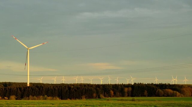 Wind Energy. A row of wind turbines in an autumn forest.Alternative energy sources.Environmentally friendly natural energy source.Natural energy