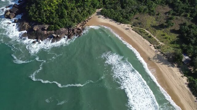 Tropical beach with clear waters, isolated amidst mountains. Praia Grande do Bonete (Desert Beach), Brazil