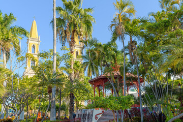 The historic Plaza Republica Square, with the red iron gazebo and Immaculate Conception church in view, in the historic center of Mazatlan, Mexico.