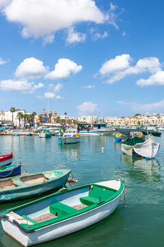 Marsaxlokk village harbor of Malta, Mediterranean traditional colorful boats luzzu.
