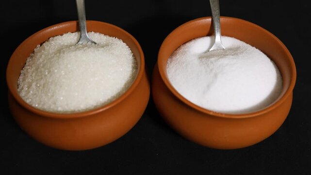 sugar and salt in ceramic bowls with spoons showcasing essential kitchen ingredients