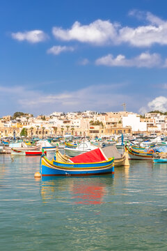 Marsaxlokk village harbor of Malta, Mediterranean traditional colorful boats luzzu.