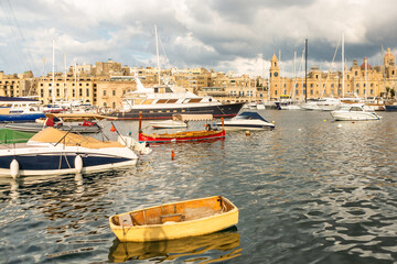 Obraz premium Marsaxlokk village harbor of Malta, Mediterranean traditional colorful boats luzzu.