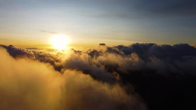 Aerial drone flying above clouds at sunrise in bromo, indonesia