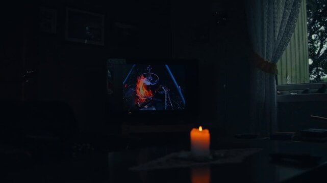 A Single Candle Flickers as a Scene Plays on the TV in Kokelv, Hammerfest, Finnmark, Norway - Handheld Shot