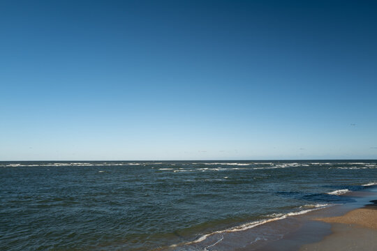 The rough waves and waters of the atlantic ocean meeting the inlet and ouotlet of the Matanzas River near St. Augustine Florida