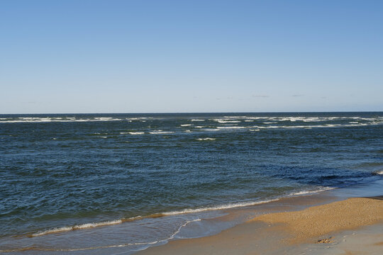 The rough waves and waters of the atlantic ocean meeting the inlet and ouotlet of the Matanzas River near St. Augustine Florida