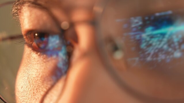 A person wearing glasses with the reflection of a glowing digital envelope in their glasses, symbolizing digital communication, online messaging, connectivity, and modern information exchange.
