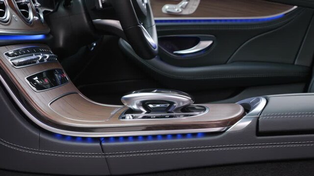 Luxury car interior with ambient lighting and polished wood details