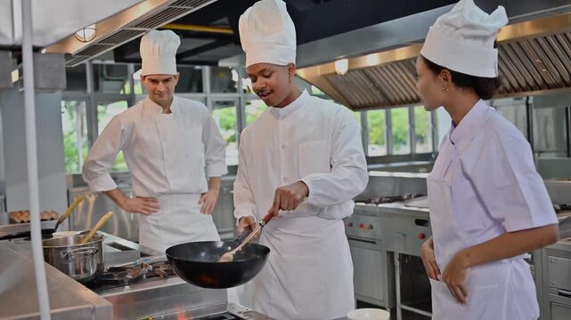Expert Chef Instructor Supervise Student Cooking With Wok In Culinary Class