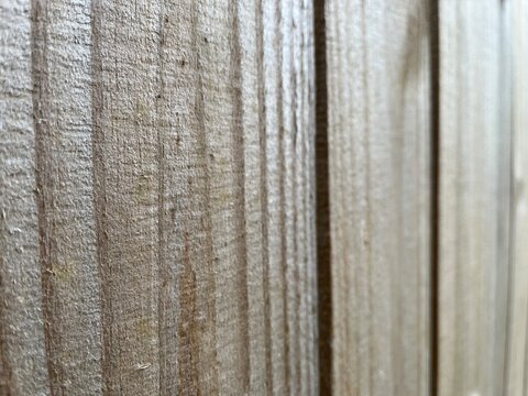 Natural Wood Plank Texture Background with Shallow Depth of Field. Natural unpainted wood plank texture background with soft lighting. Natural wood fence with selective focus.