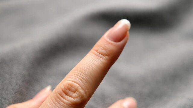Close up of female hands removing silver or white gold ring from finger