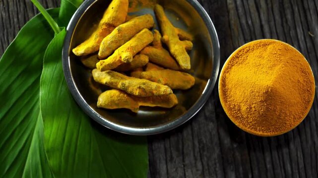 top view of turmeric ground and root on wood background.