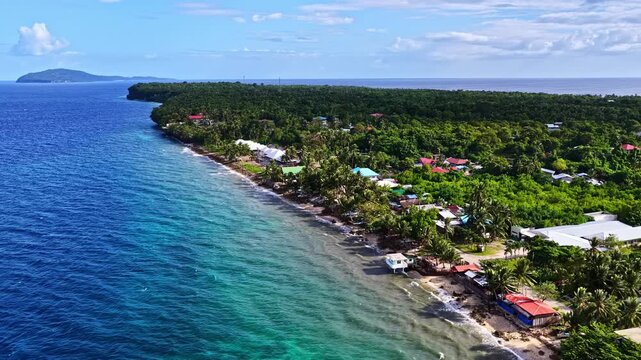 Flying over the tropical coastline of Padre Burgos, Southern Leyte in Philippines